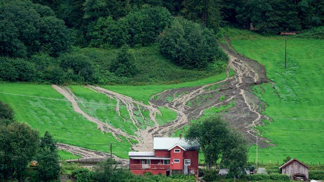 A landslide is seen on a slope behind a house in Valdres, Nord Aurdal, near Bagn, Norway on August 8, 2023, as extreme weather 'Hans' has hit eastern Norway. The Meteorological Institute has issued a red warning for very heavy rain, floods and landslides in Viken north of Oslo, Innlandet and parts of Trøndelag.