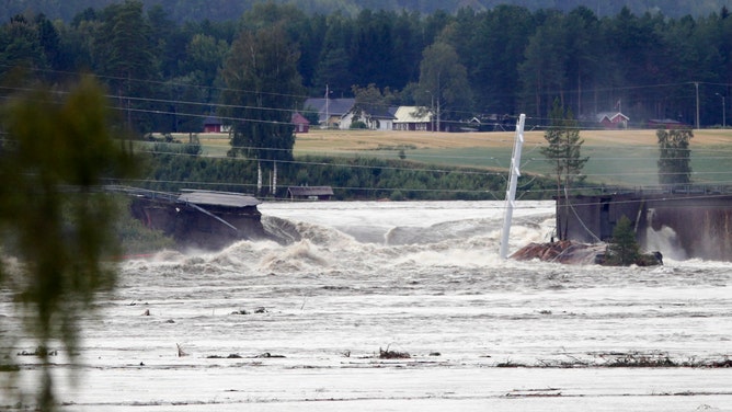 Water flows after the dam burst at the Braskereidfoss Power plant, Norway with water flowing into the Glomma river after floodgates did not open properly, on August 9, 2023. Norwegian authorities said on August 9 thousands had been evacuated following massive floods and that they were considering blowing open a dam after the floodgates failed to open.