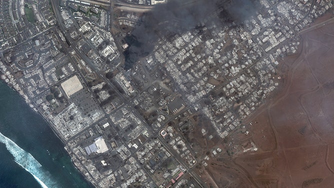 Maxar satellite imagery shows the Lahaina square's destruction and outlets after the Lahaina Wildfire, with one building still actively burning. 