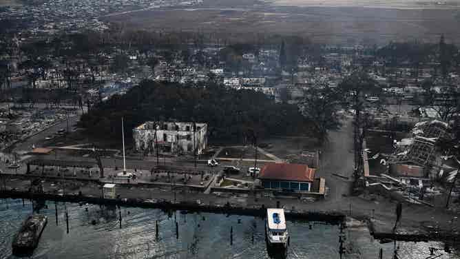 An aerial view shows the historic Banyan Tree along with destroyed homes, boats, and buildings burned to the ground in the historic Lahaina town in the aftermath of wildfires in western Maui in Lahaina, Hawaii, on August 10, 2023. At least 36 people have died after a fast-moving wildfire turned Lahaina to ashes, officials said August 9, as visitors asked to leave the island of Maui found themselves stranded at the airport. The fires began burning early August 8, scorching thousands of acres and putting homes, businesses and 35,000 lives at risk on Maui, the Hawaii Emergency Management Agency said in a statement. (Photo by Patrick T. Fallon / AFP) (Photo by PATRICK T. FALLON/AFP via Getty Images)