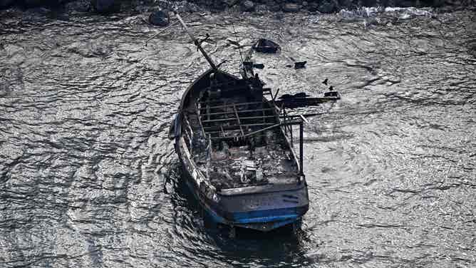 An aerial image taken on August 10, 2023 shows a burned boat in the Lahaina Harbor in the aftermath of wildfires in western Maui, Hawaii. At least 36 people have died after a fast-moving wildfire turned Lahaina to ashes, officials said August 9, 2023 as visitors asked to leave the island of Maui found themselves stranded at the airport. The fires began burning early August 8, scorching thousands of acres and putting homes, businesses and 35,000 lives at risk on Maui, the Hawaii Emergency Management Agency said in a statement. (Photo by Patrick T. Fallon / AFP) (Photo by PATRICK T. FALLON/AFP via Getty Images)