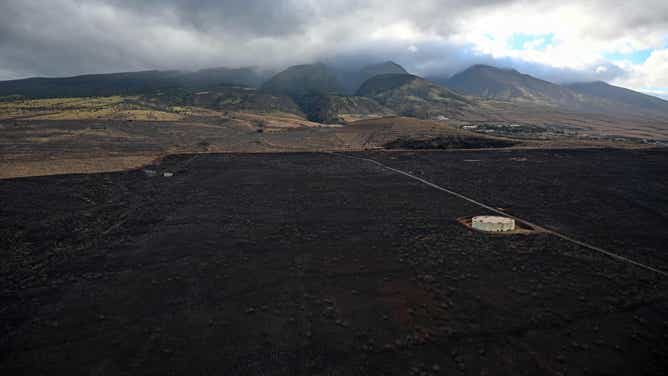 An aerial image taken on August 10, 2023 shows a burned hillside above Lahaina in the aftermath of wildfires in western Maui in Lahaina, Hawaii. At least 36 people have died after a fast-moving wildfire turned Lahaina to ashes, officials said August 9, 2023 as visitors asked to leave the island of Maui found themselves stranded at the airport. The fires began burning early August 8, scorching thousands of acres and putting homes, businesses and 35,000 lives at risk on Maui, the Hawaii Emergency Management Agency said in a statement. (Photo by Patrick T. Fallon / AFP) (Photo by PATRICK T. FALLON/AFP via Getty Images)