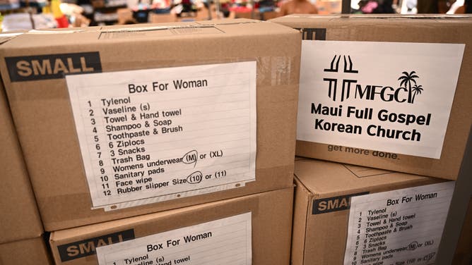 Boxes of donated supplies from the Maui Full Gospel Korean Church await distribution to fire victims in the aftermath of wildfires in western Maui in Wailuku, Hawaii on August 12, 2023. Hawaii's Attorney General, Anne Lopez, said August 11, she was opening a probe into the handling of devastating wildfires that killed at least 80 people in the state this week, as criticism grows of the official response. The announcement and increased death toll came as residents of Lahaina were allowed back into the town for the first time.