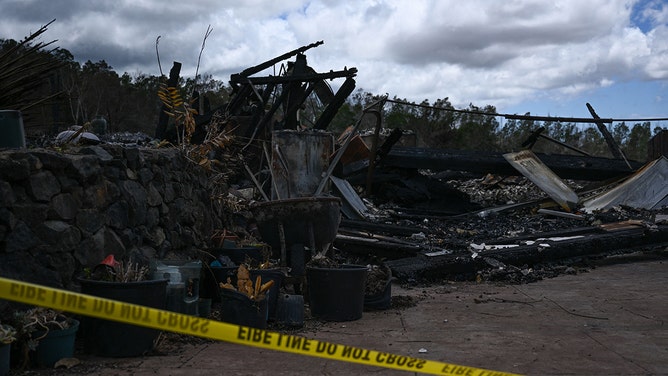 Police tape surrounds the site of a home destroyed by the Maui wildfires in Kula, Hawaii on August 13, 2023.