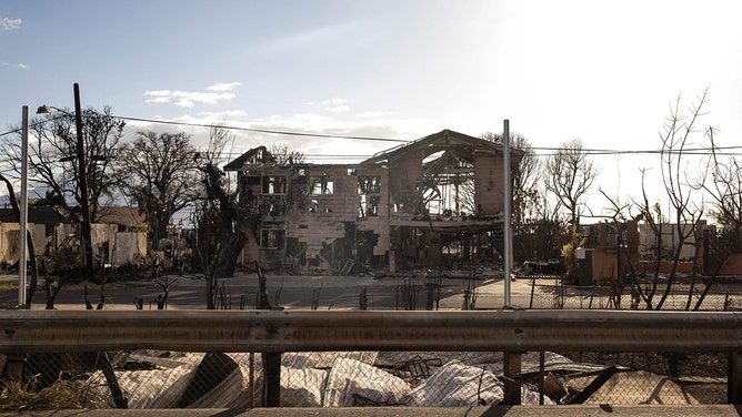 The charred frame of a house is seen among the ashes of a burnt neighborhood in the aftermath of a wildfire, in Lahaina, western Maui, Hawaii on August 14, 2023.