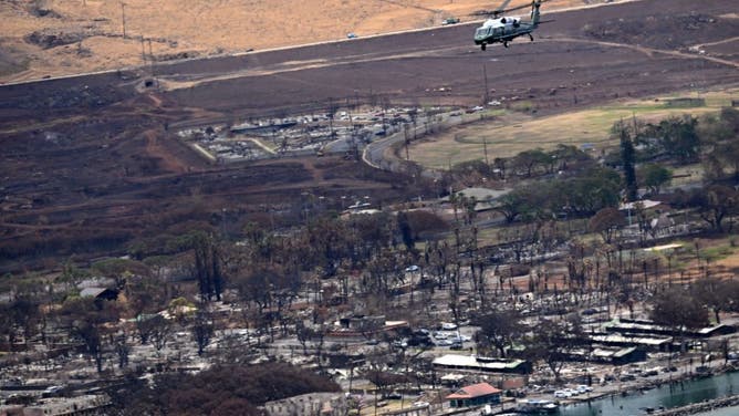 Marine One, carrying US President Joe Biden, flies above wildfire damage in Lahaina on the island of Maui, in Hawaii on August 21, 2023.