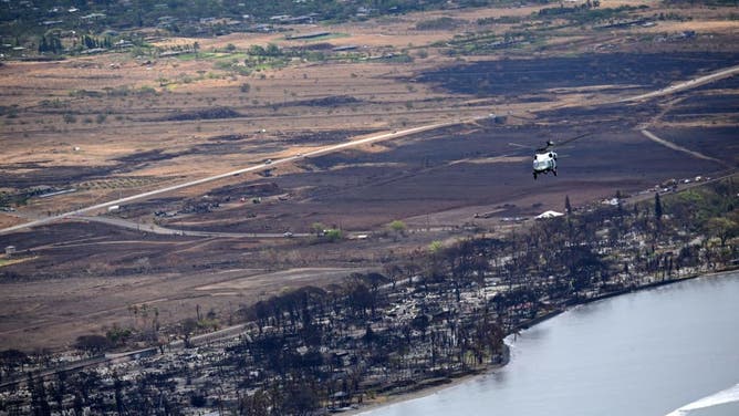 Marine One, carrying US President Joe Biden, flies above wildfire damage in Lahaina on the island of Maui, in Hawaii on August 21, 2023.