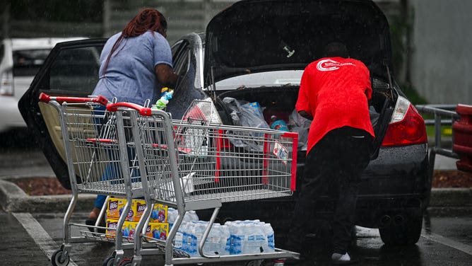 People stock up on food and water in Tampa, Florida, on August 29, 2023 as the city prepares for Hurricane Idalia. Hurricane Idalia intensified Tuesday as it churned toward the west coast of Florida, triggering mass evacuation orders and flood alerts as authorities warned of life-threatening ocean surge and catastrophic destruction when the storm rages ashore early Wednesday. (Photo by Miguel J. Rodriguez Carrillo / Miguel J. Rodriguez Carrillo / AFP) (Photo by MIGUEL J. RODRIGUEZ CARRILLO/Miguel J. Rodriguez Carrillo/AFP via Getty Images)