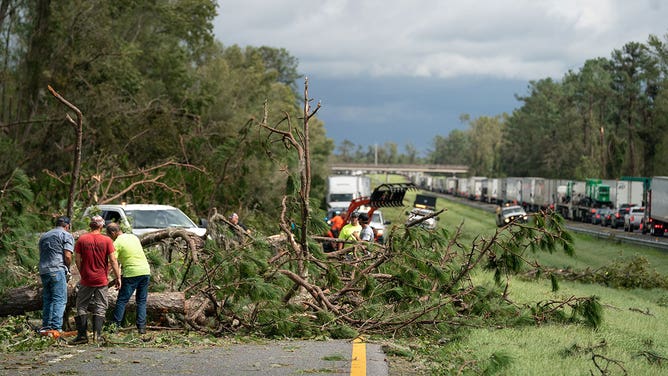 People work to clear I-10 of fallen trees after Hurricane Idalia crossed the state on August 30, 2023 near Madison, Florida.