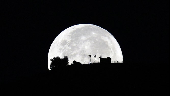 The super blue moon is pictured over Nablus on August 31, 2023.