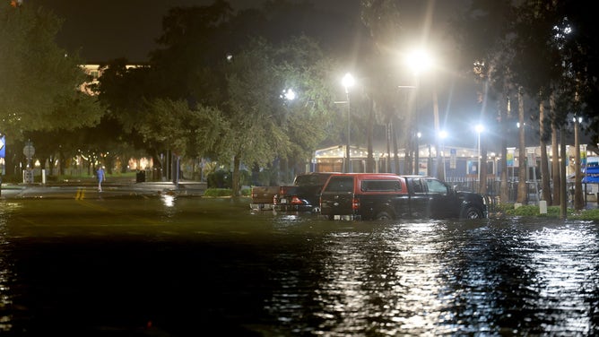 ST PETERSBURG, FLORIDA - AUGUST 30: Vehicles sit in a flooded street caused by Hurricane Idalia passing offshore on August 30, 2023 in St. Petersburg, Florida. Hurricane Idalia is hitting the Big Bend area of Florida.
