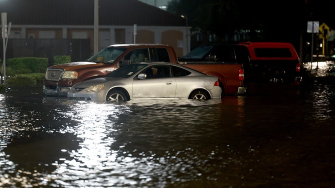 ST PETERSBURG, FLORIDA - AUGUST 30: Vehicles sit in a flooded street caused by Hurricane Idalia passing offshore on August 30, 2023 in St. Petersburg, Florida. Hurricane Idalia is hitting the Big Bend area of Florida.