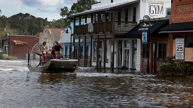An airboat passes through flood waters in the downtown area after Hurricane Idalia passed offshore on August 30, 2023, in Crystal River, Florida.