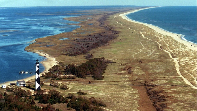 The lighthouse at Cape Lookout, N.C., so tall when viewed up close, becomes rather small when seen in this file aerial view of Core Banks.