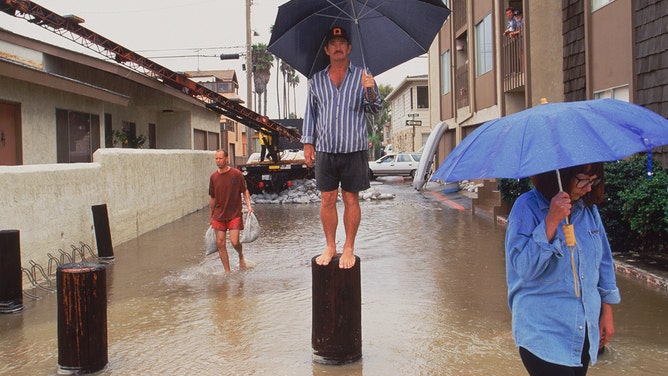 Seal Beach residents are seen among flooding on Sept. 25, 1997, after Hurricane Nora near Los Angeles in Southern California.