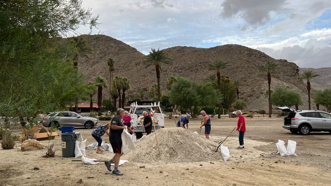 Filling sand bags in the California desert
