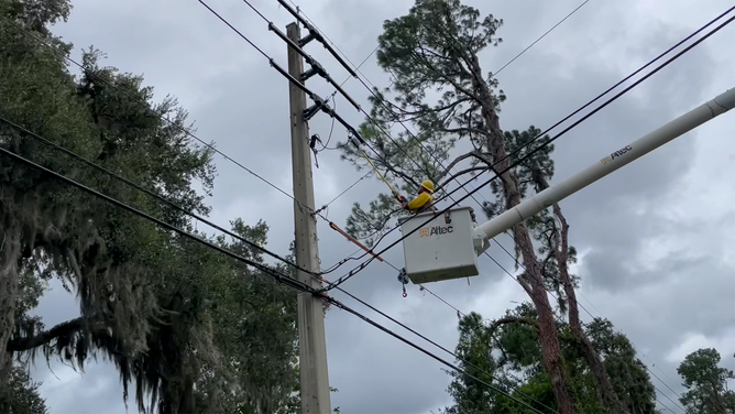 A utility worker is seen working to restore power after Hurricane Idalia.