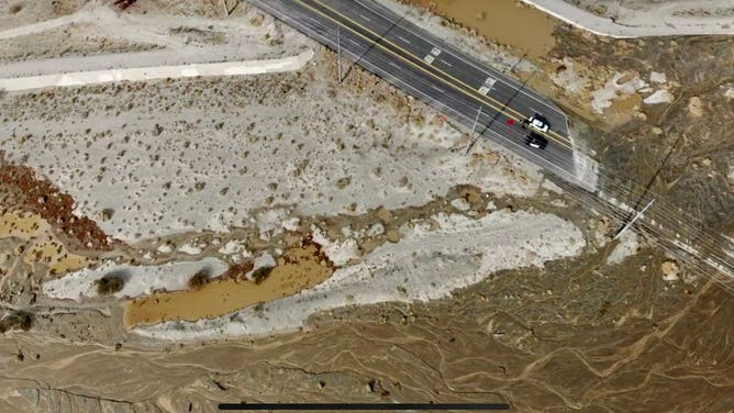 A screenshot of drone video shows flooding damages on on Gene Autry Trail in Palm Springs, California.