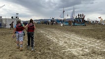 Flood-stranded Burning Man revelers begin mass exodus after monsoon rains trapped festivalgoers