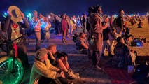 Burning Man attendees bond while making most of muddy mess