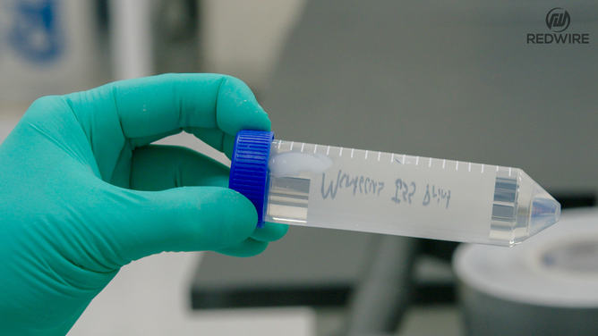 Redwire science team members opening the BFF-Meniscus-2 experiment, at the International Space Station Processing Facility. (Image credit: Redwire)