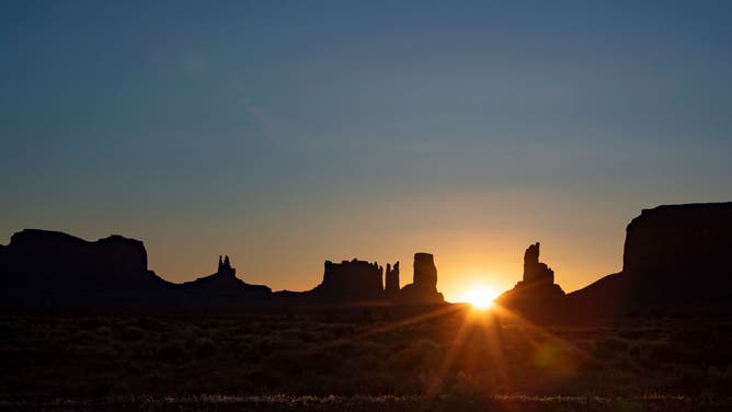 File photo: Dawn breaks over sandstone formations at the Monument Valley Navajo Tribal Park on the Navajo Reservation on Sunday, May 24, 2020 in Oljato-Monument Valley, AZ.