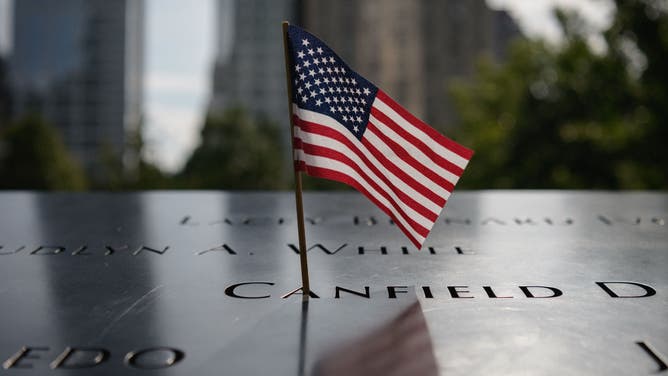 A US Flag adorns a name at the National September 11 Memorial site of the north tower at World Trade Center in New York, on September 8, 2021. - The remains of two more victims of 9/11 have been identified, thanks to advanced DNA technology, New York officials announced on September 7, 2021, just days before the 20th anniversary of the attacks. The office of the city's chief medical examiner said it had formally identified the 1,646th and 1,647th victim of the al-Qaeda attacks on New York's Twin Towers which killed 2,753 people. (Photo by Angela Weiss / AFP) (Photo by ANGELA WEISS/AFP via Getty Images)