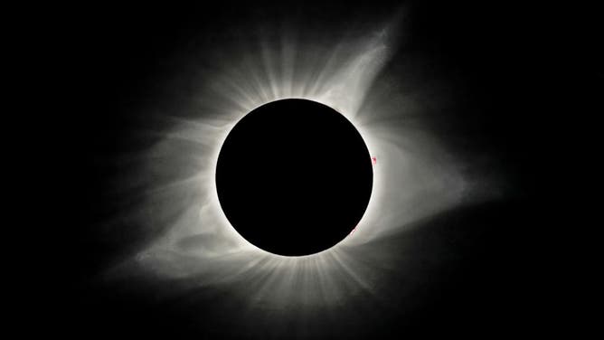 The sun's corona is visible as the moon obscures the sun during the Great American Solar Eclipse at Madras High School in Madras, Oregon, on Monday, August 21, 2017.