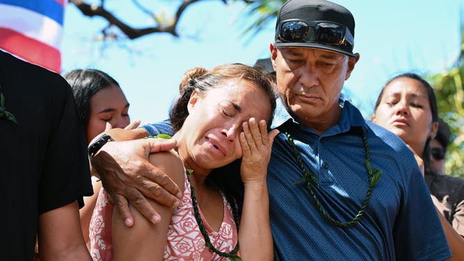 LAHAINIA, HI- AUGUST 18: Tiare Lawrence is comforted by Archie Kalepa as community members hold a press conference at Wahikuli Beach Park to address issues concerning the fire in Lahaina on Friday August 18, 2023 in Lahania, HI. The death toll continues to rise for the fires on Maui. (Photo by Matt McClain/The Washington Post via Getty Images)