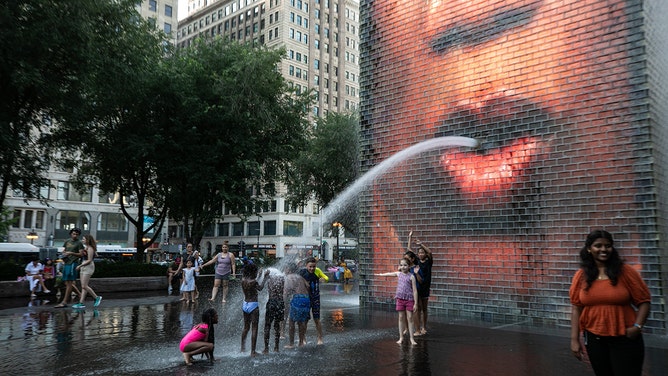 Children cool down at Crown Fountain in downtown Chicago, the United States, on Aug. 23, 2023.