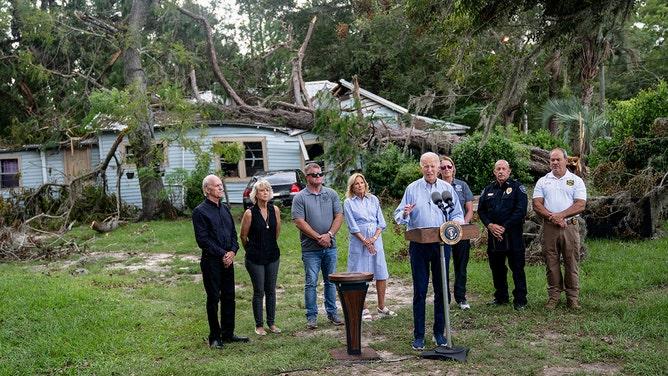 President Joe Biden speaks in front of a home destroyed by fallen trees and debris during a tour of communities impacted by Hurricane Idalia with US First Lady Jill Biden in Live Oak, Florida, on September 2, 2023.