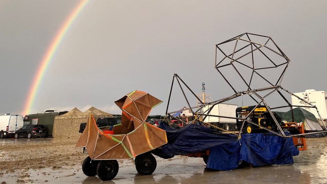 04 September 2023, USA, Black Rock: The undated image shows a rainbow seen over the muddy grounds of the "Burning Man" festival. Tens of thousands of visitors to the desert festival "Burning Man" are stranded on the site in the US state of Nevada after heavy rainfall over the weekend. Photo: David Crane/dpa (Photo by David Crane/picture alliance via Getty Images)