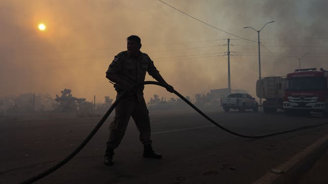Firefighters battle a fire in an area of the Amazon rainforest in Iranduba, metropolitan region of Manaus, Amazonas state, Brazil, on September 5, 2023.
