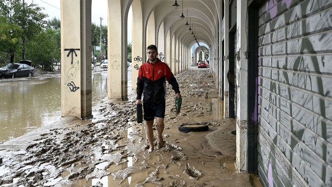 A local resident walks in a flooded street in Volos, central Greece, on September 6, 2023. The regional capital Volos has seen about 8 inches of rain, according to the National Meteorological Service (EMY).