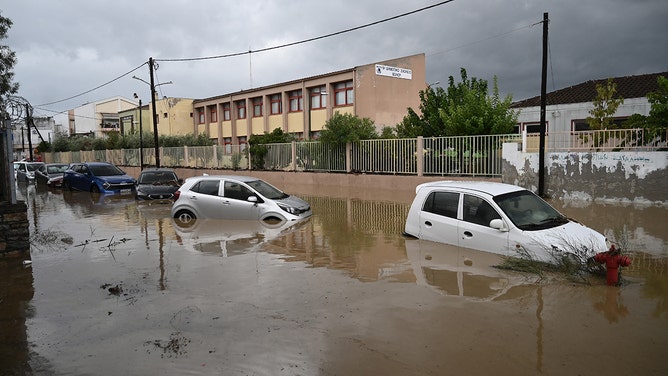 A photo shows cars in a flooded road in the city of Volos, central Greece, on September 6, 2023.