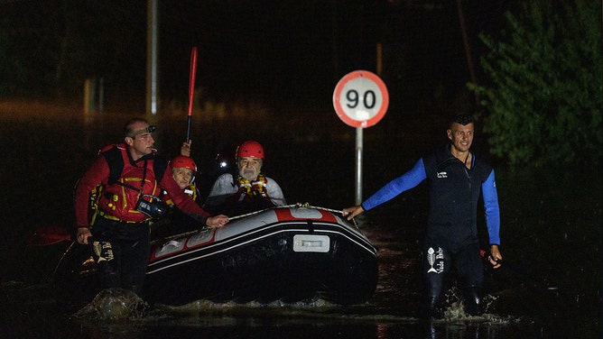 Rescue workers help residents move through flood water on an inflatable boat following heavy rains caused by Storm Daniel in Melissochori, Larissa, Greece, on Wednesday, Sept. 6, 2023.