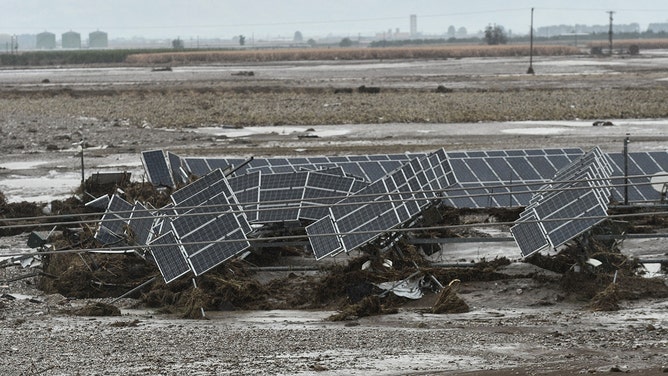 Damaged solar panels are swept together in a field after heavy rains, near Larisa, central Greece on September 7, 2023.
