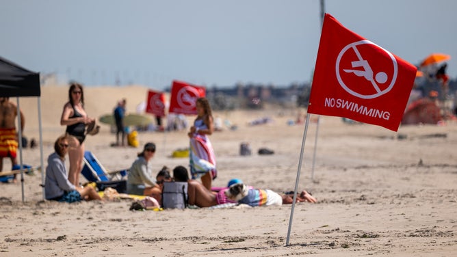 NEW YORK, NEW YORK - AUGUST 31: Flags warn that the beach is closed to swimmers at Rockaway Beach in New York as high surf from Hurricane Franklin delivers strong rip tides and large waves to most of the eastern seaboard on August 31, 2023 in New York City. Numerous beaches across New York and Long Island were closed to swimming as a result of rip tides from the storm which has now moved out into the Atlantic. (Photo by Spencer Platt/Getty Images)