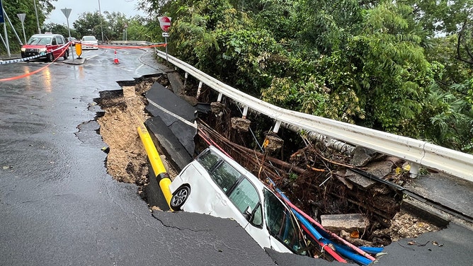 This picture shows a vehicle in a collapsed section of road in Hong Kong on September 8, 2023.