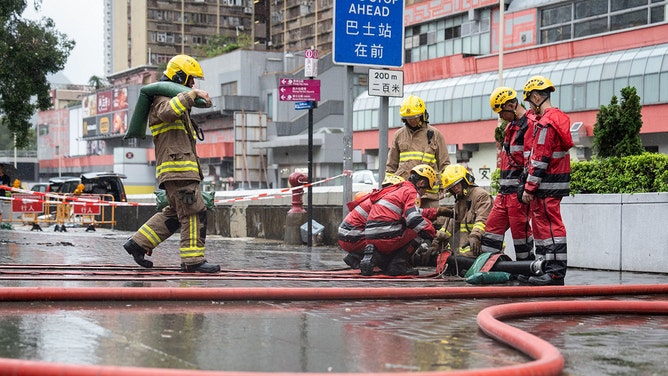 Firemen clear up a road in Hong Kong on September 8, 2023.