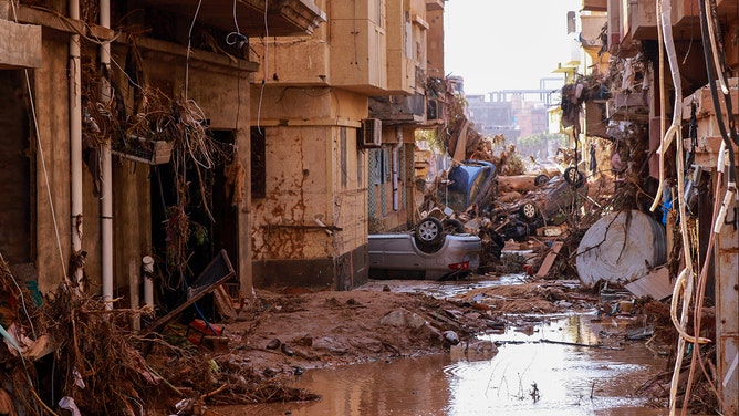 Overturned cars lay among other debris caused by flash floods in Derna, eastern Libya, on September 11, 2023.