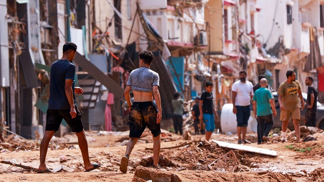 People check an area damaged by flash floods in Derna, eastern Libya, on September 11, 2023.