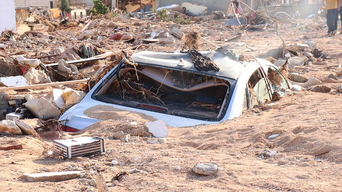 A damaged vehicle is stuck debris after the floods caused by the Storm Daniel ravaged disaster zones in Derna, Libya on September 12, 2023.