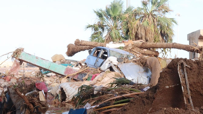 A damaged vehicle is stuck debris after the floods caused by the Storm Daniel ravaged disaster zones in Derna, Libya on September 12, 2023.