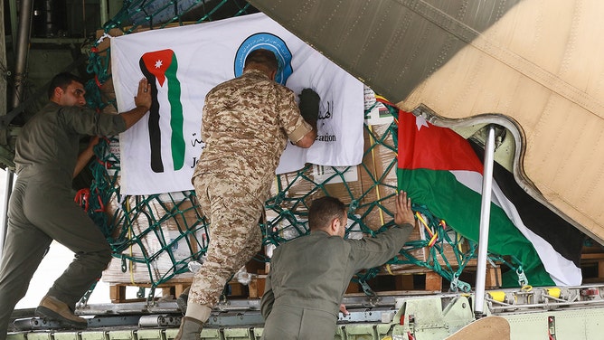 Workers load a Jordanian military plane with humanitarian aid to Libya, at Marka military airport in Amman, on September 13, 2023. At least 30,000 Libyans have been left homeless in the eastern city of Derna in devastating flash floods unleashed by Storm Daniel, the International Organization for Migration said on September 13.