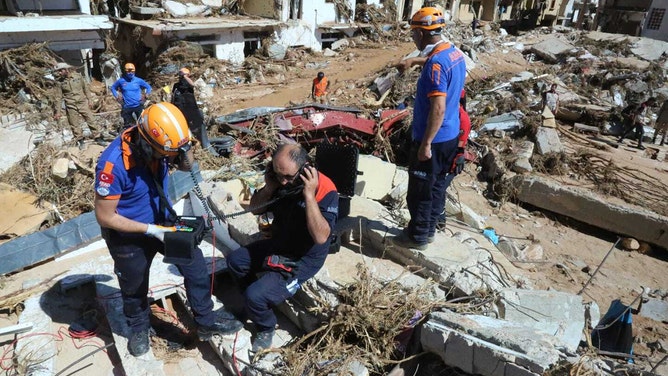 Teams of Turkiye's State Disaster and Emergency Management Authority (AFAD) join search and rescue operations to save lives following devastating floods in Libya on September 13, 2023.