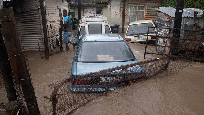 A view of cars covered with water and mud during heavy flooding as a result of a storm in Sir Lowry's Village, close Somerset West on September 25, 2023.