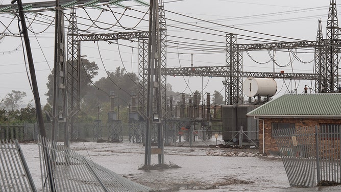Flood waters flow through an electrical substation during heavy flooding as a result of a storm in Somerset West on September 25, 2023.