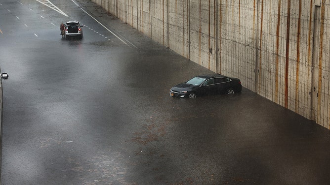 A vehicle sits submerged after it got stuck in high water on the Prospect Expressway during heavy rain and flooding on September 29, 2023 in the Brooklyn Borough of New York City.