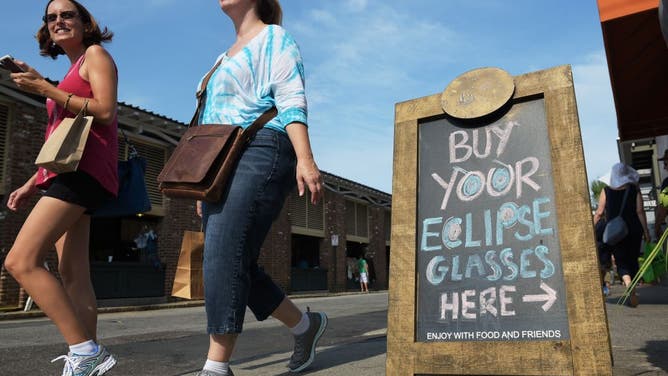 A board advertises eclipse glasses for sale at a restaurant ahead of the total solar eclipse in Charleston, South Carolina, on August 20, 2017.